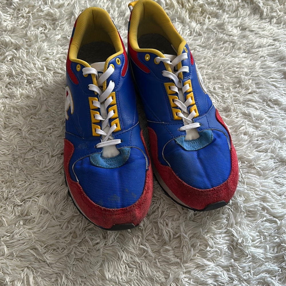 A pair of Champion shoes. Size 12 in men’s. Red, blue, white and yellow